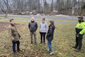 (PHOTO: James Ward, Rye Sustainability Committee chair (black jacket) on Playland Parkway discussing invasive plant removal and native planting plans with (L to R) committee members Chris Cohan, (Ward) and Tracy Stora, along with Westchester County planning and park officials.)