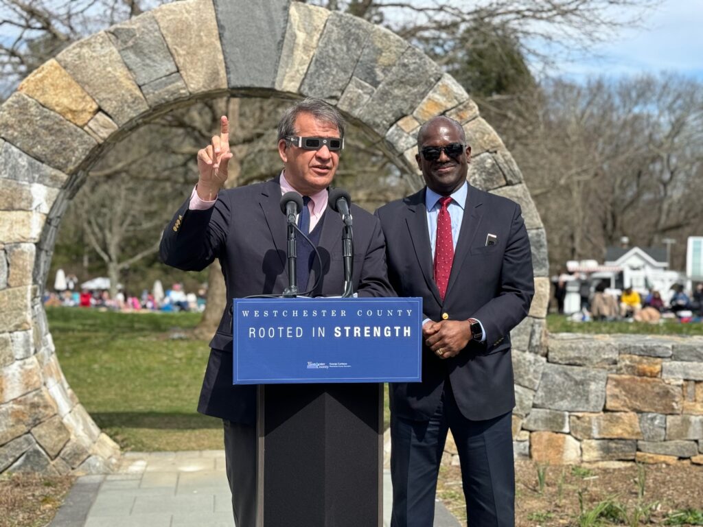 (PHOTO: Rye Guy and County Boss George Latimer, along with Deputy Boss Ken Jenkins, gazed towards the heavens at Lason Park and Arboretum during a solar eclipse viewing event on Monday, April 8, 2024.)