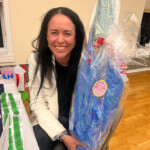 (PHOTO: At The Children's Philanthropy of Rye's Mahjong for a Cause! fundraiser, Meghann Kelly shows off one of the big ticket raffle prizes courtesy of The Mahjong Line.)