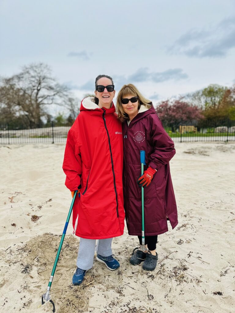 (PHOTO: Bad sisters Trish O'Gorman and Sian Roath at the Rye Town Park Oakland Beach cleanup on Sunday, April 21, 2024 (before their cold plunge).)