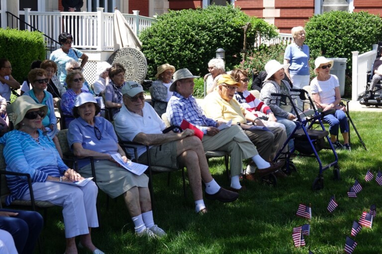 (PHOTO: Osborn’s Grandview residents enjoy a beautiful day on our South Lawn celebrating an intergenerational Flag Day program with Rye elementary schools.)