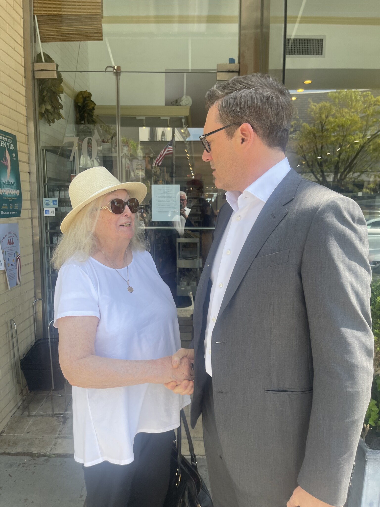 (PHOTO: Hamm-ing it up. Actor Jon Hamm on Purchase Street in front of June & Ho in Rye on Monday, April 29, 2024. He was greeted by fan Sue Higgins. Higgins is the mom of local residents Kat Doyle and Amy Donovan.)