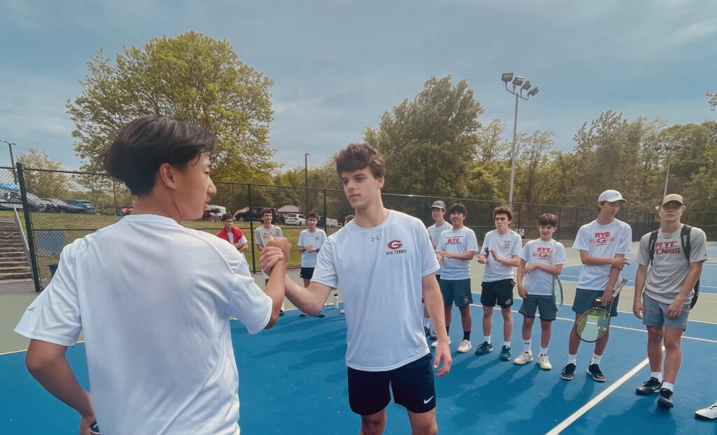 (PHOTO: Rye Boys Varsity Tennis team player Nicolas Echlov shaking hands on Tuesday in the match against Clarkstown South.)