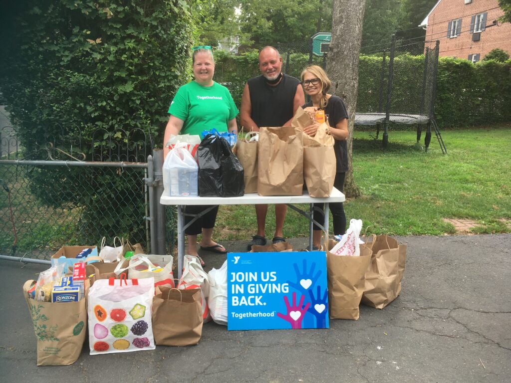 (PHOTO: The Rye YMCA 2022 drive for the Bread of Life (left to right: Vanessa Mayo, Togetherhood Committee; Pastor Pasquale Falco, Bread of Life; and Valerie Guglielmo, Togetherhood Committee.)