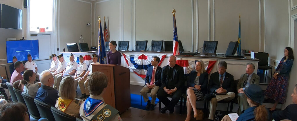 (PHOTO: The 2024 John M. Kingery Memorial Essay winner Madeline Kilroy delivering her Memorial Day remarks at City Hall on Monday, May 27, 2024.)