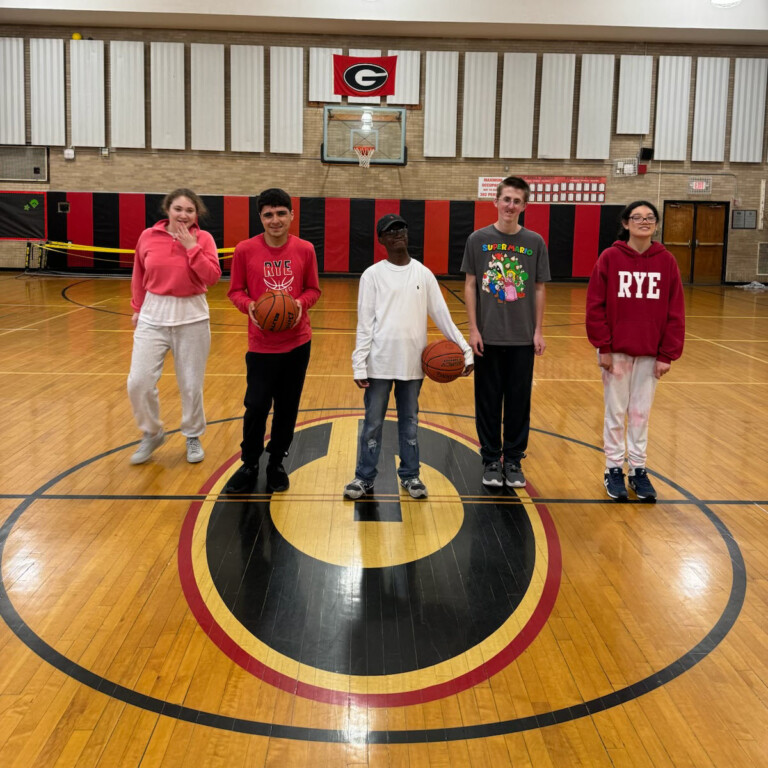 (PHOTO: The 2024 Rye Unified Basketball team: Emma Sassower, Thomas Weckessar, Zafeer Olatidoye, TJ Neeves, Julie Purcell, Alex Elovaara (not pictured).)