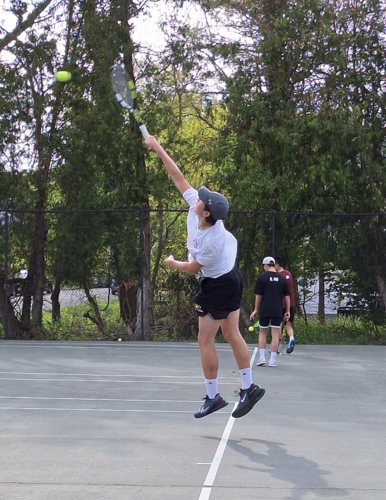 (PHOTO: Rye Boys Varsity Tennis player Henry Groves serving at number one on Wednesday, May 1, 2024.)