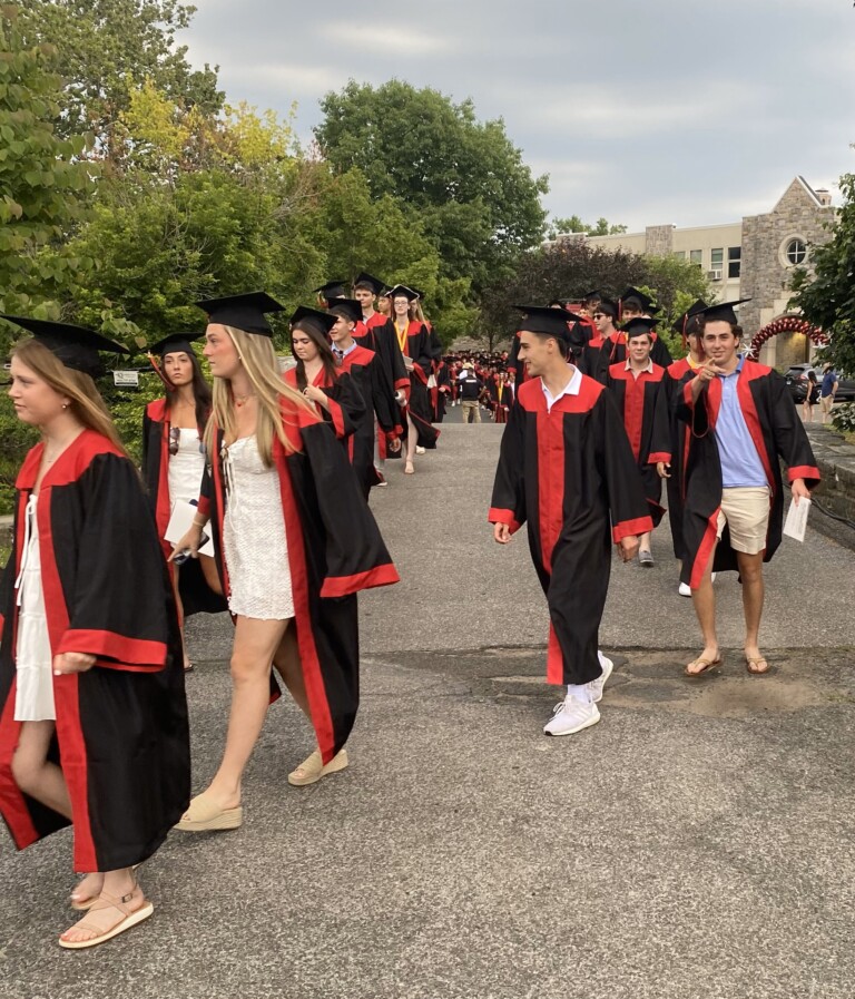 (PHOTO: Members of the Rye High School Class of 2024 walk the bridge before receiving their diplomas on Friday, June 21, 2024.)