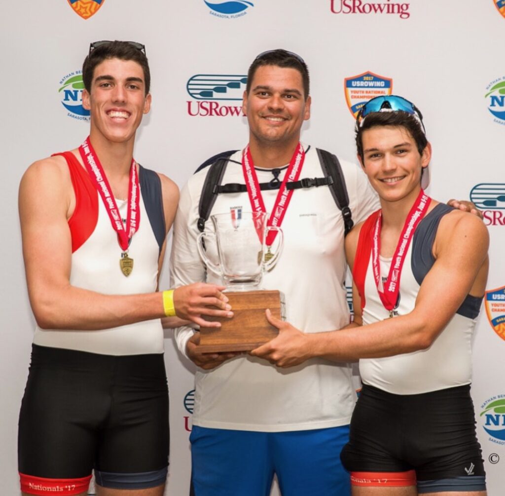 (PHOTO: Rodriguez with RowAmerica Rye Coach Aleks Radovic and Sean Hayes receiving their award at USRowing Youth Nationals for winning the men's pair.)