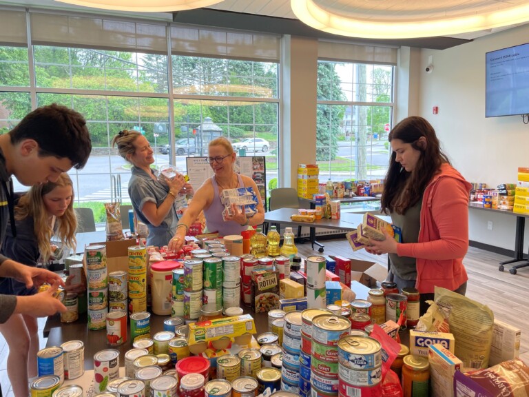 (PHOTO: Volunteers sort donated food during the Rye YMCA's 2024 food drive, part of its ongoing community service programs. Contributed.)