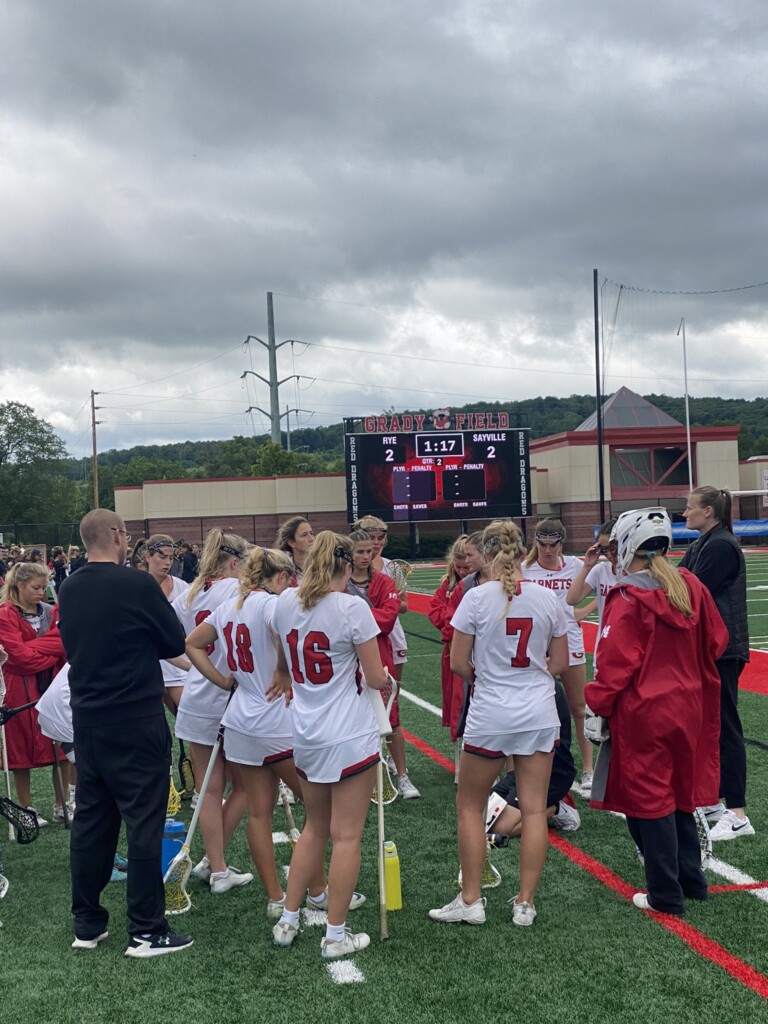 (PHOTO: Rye huddles after the first quarter in Saturday's loss to Sayville.)