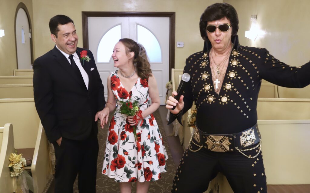 (PHOTO: For their 10th wedding anniversary, Amy Wadford and Leo Lawrence traveled to Vegas and renewed their vows in front of an Elvis Presley impersonator. This Friday, August 16, 2024, five years later, they will exchange their vows in front of the world's largest rubber duck at Playland Beach.)