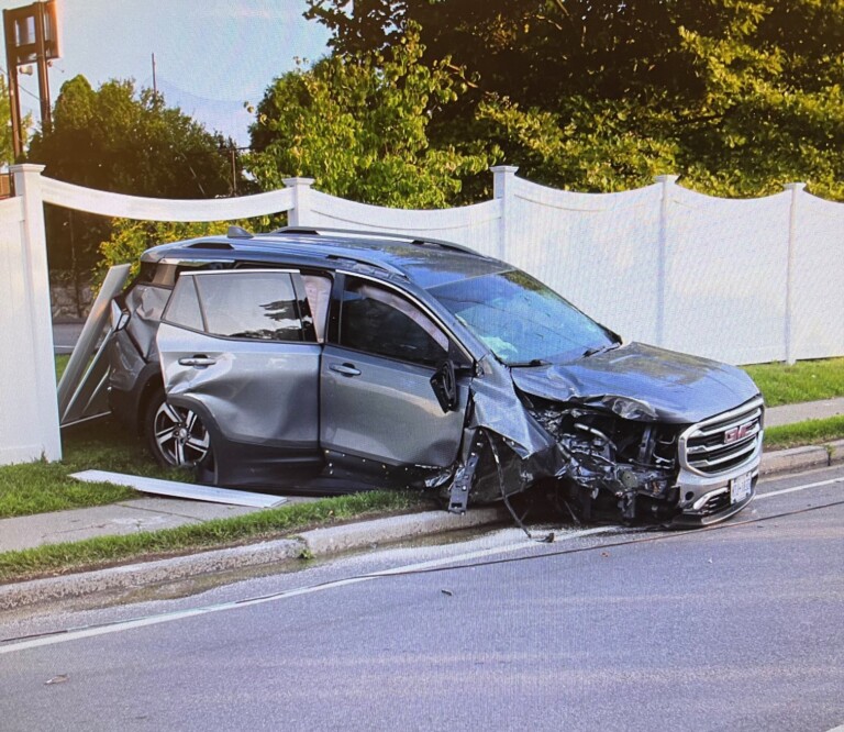 (PHOTO: Around 7am on Saturday, August 24, 2024 a 4-door GMC SUV hit a telephone pole and went through a fence the Boston Post Road near the intersection of Cedar Street, alongside the property of Rye Country Day School. Source: Rye PD.)