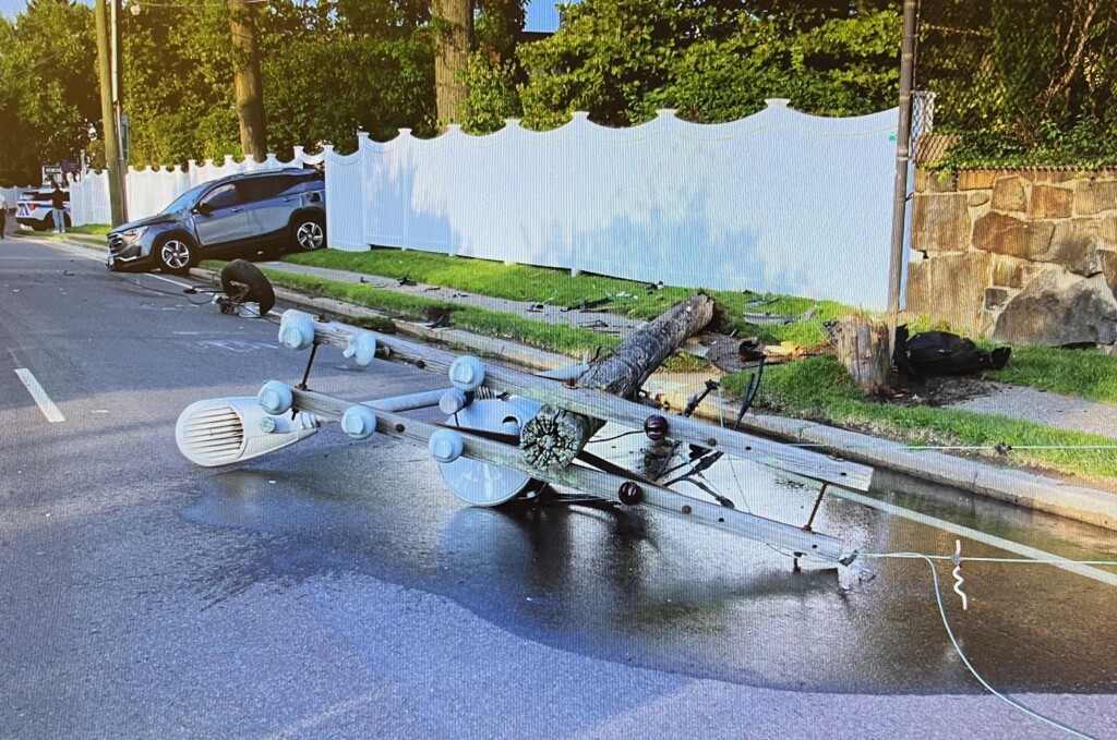 (PHOTO: Around 7am on Saturday, August 24, 2024 a 4-door GMC SUV hit a telephone pole and went through a fence the Boston Post Road near the intersection of Cedar Street, alongside the property of Rye Country Day School. Source: Rye PD.)