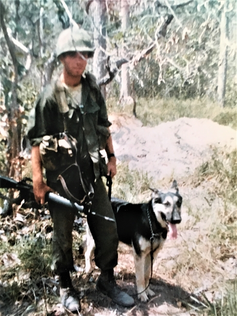 (PHOTO: US Army veteran and Theodore Fremd Avenue resident Fred De Barros on patrol in 1967 in Dau Tieng, South Vietnam as part of the 44th Infantry Platoon Scout Dogs with his German shepherd Tinzer.)