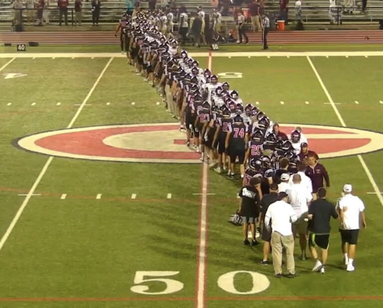 (PHOTO: Rye shakes hands with Monsignor Farrell after its comeback victory on Friday night in Week 0.)