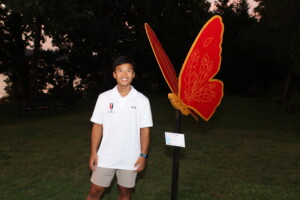 PHOTO: Young artist Thomas Chen poses with his work.