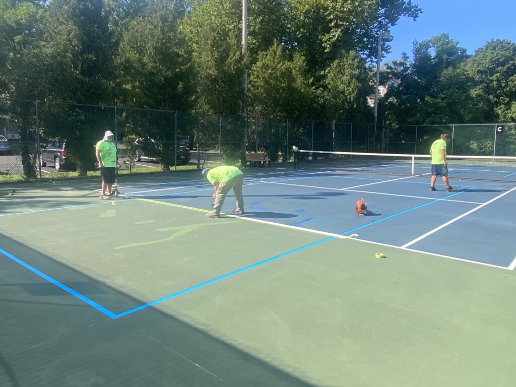 (PHOTO: Workers lining the four new pickleball courts on Tuesday, September 3, 2024. The courts opened on Thursday.)