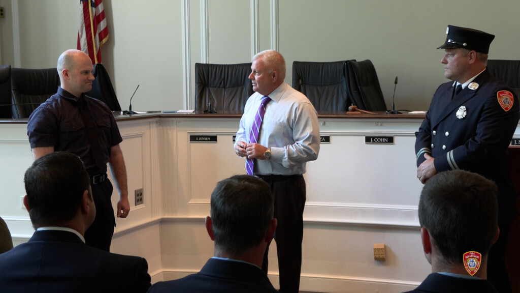 (PHOTO: Tyler Conway was sworn in as the newest Rye FD firefighter in a City Hall ceremony on Tuesday, September 3, 2024. Conway shown here with Public Safety Commissioner Mike Kopy and FD Captain Clyde Pitts . Contributed: Rye FD.)