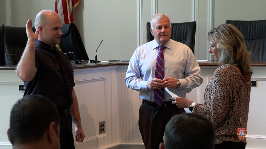 (PHOTO: Tyler Conway was sworn in as the newest Rye FD firefighter in a City Hall ceremony on Tuesday, September 3, 2024. Conway shown here with Public Safety Commissioner Mike Kopy and Rye City Clerk Noga Ruttenberg. Contributed: Rye FD.)