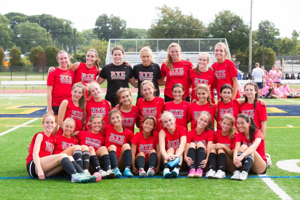 (PHOTO: The Girls Varsity Soccer Team poses following its 3-0 win in its season opener on September 7.)