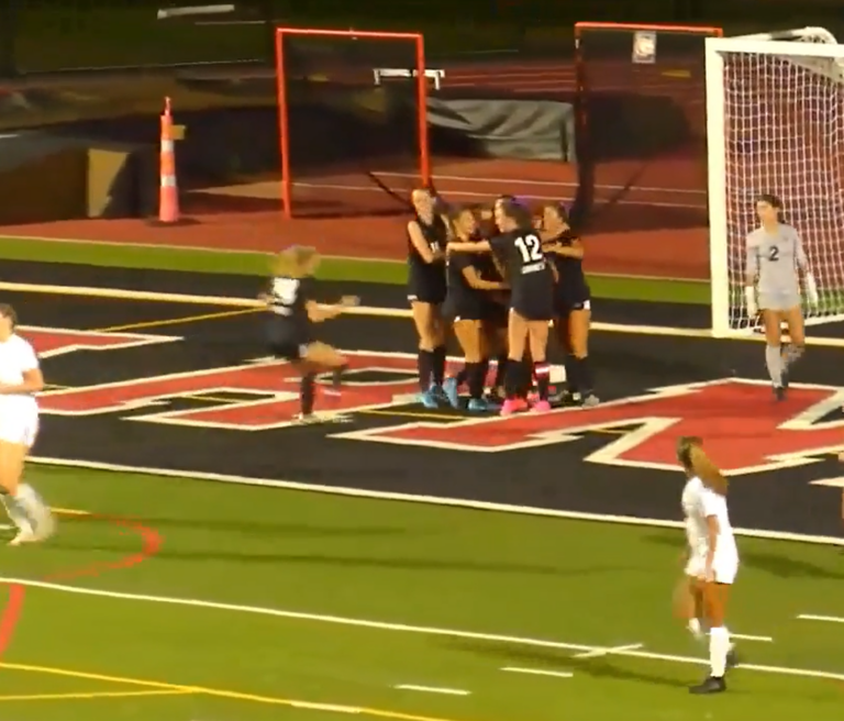 (PHOTO: Girls Soccer gathers around Lyla Keenan after she scored the icebreaking goal against Tappan Zee on Saturday.)