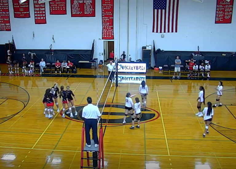 (PHOTO: Rye Volleyball huddles after losing a rare point against Riverside on Tuesday evening.)