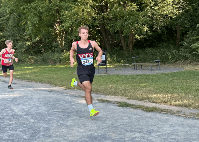 (PHOTO: Junior Ben Truman surges during the last 400m of the Regis Invitational on September 14.)