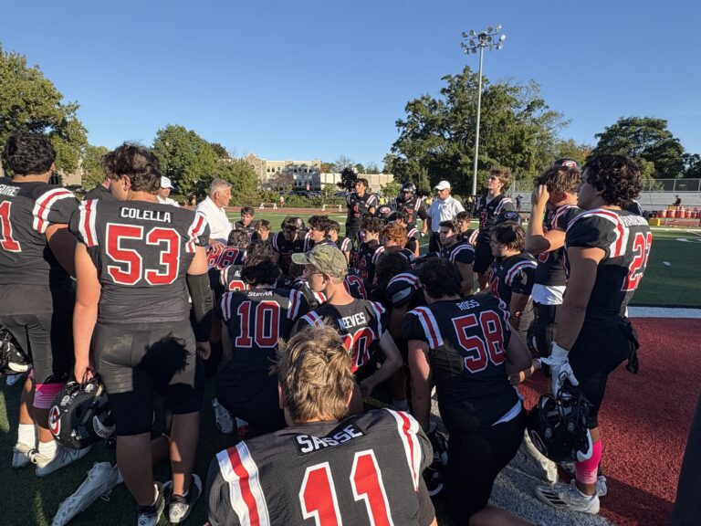 (PHOTO: The Rye Varsity Football Team gathered around Head Coach Dino Garron Saturday afternoon. The Garnets defeated Clarkstown South 21-0.)