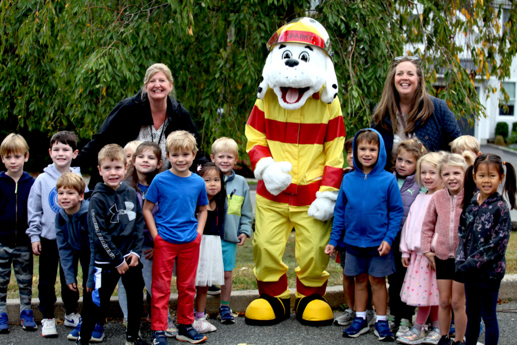 (PHOTO: Rye FD held and open house on Sunday, October 6, 2024 during fire prevention week.  The event featured a Sparky the Fire Dog mascot, seen here with local residents. Contributed.)