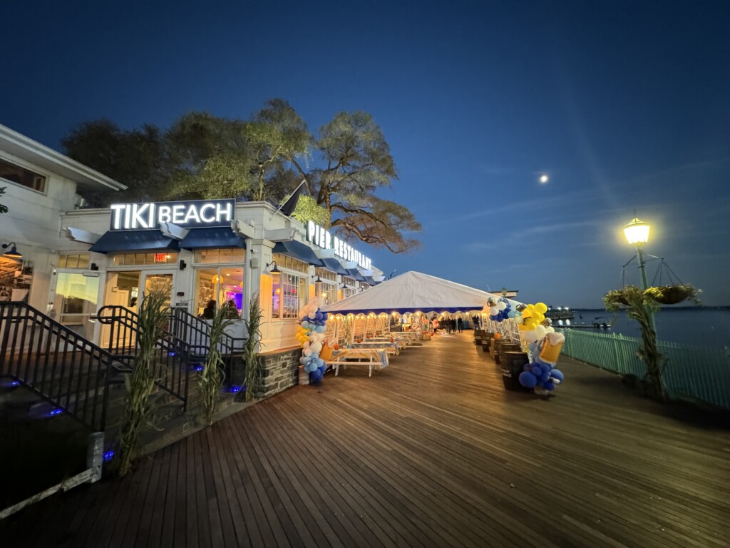 (PHOTO: Jeff Provenzano – 1994 Rye High School grad, professional stuntman and member of the Red Bull Air Force – skydived onto Rye Playland Beach on Saturday, October 12th at 6:00pm. The jump coincided with the Octoberfest celebration at the Tiki Bar.)