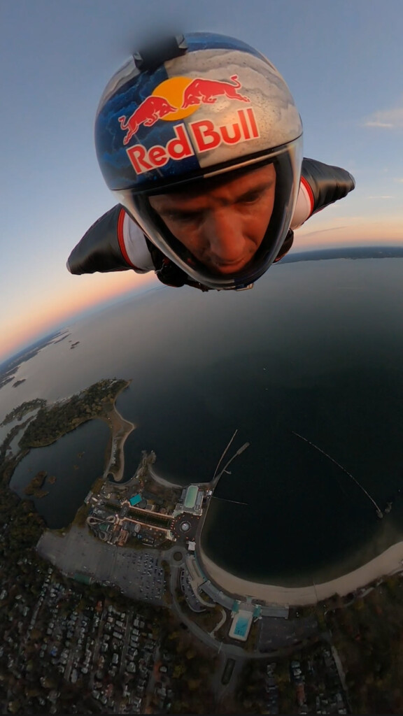 (PHOTO: Jeff Provenzano – 1994 Rye High School grad, professional stuntman and member of the Red Bull Air Force – skydived onto Rye Playland Beach on Saturday, October 12th at 6:00pm. Here is Provenzano high above Playland Beach.)