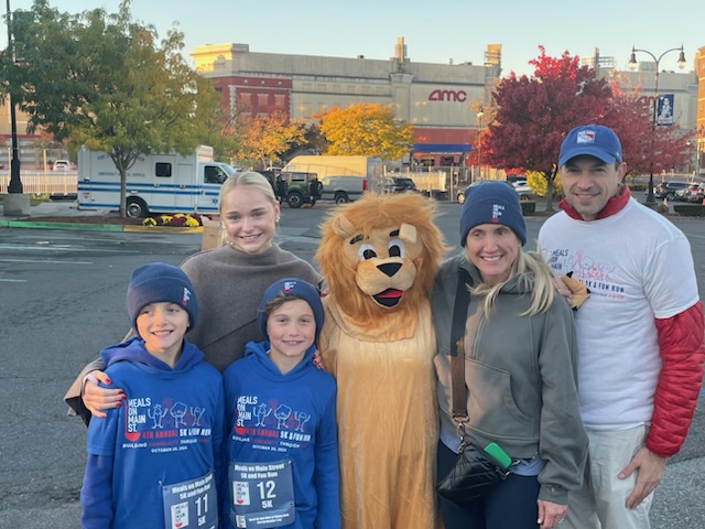 (PHOTO: The 4th Annual MOMS 5k and Family Fun Run took place in Port Chester on Sunday, October 20, 2024. Runners and the Milton Lion from the Milton Elementary School team.)