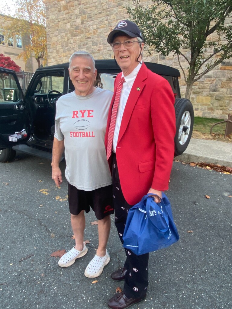 (PHOTO: Rye Varsity Football Coach Dino Garr after Saturday's victory over Harrison with Nugent Stadium announcer and Old Garnet Steve Feeney.) 