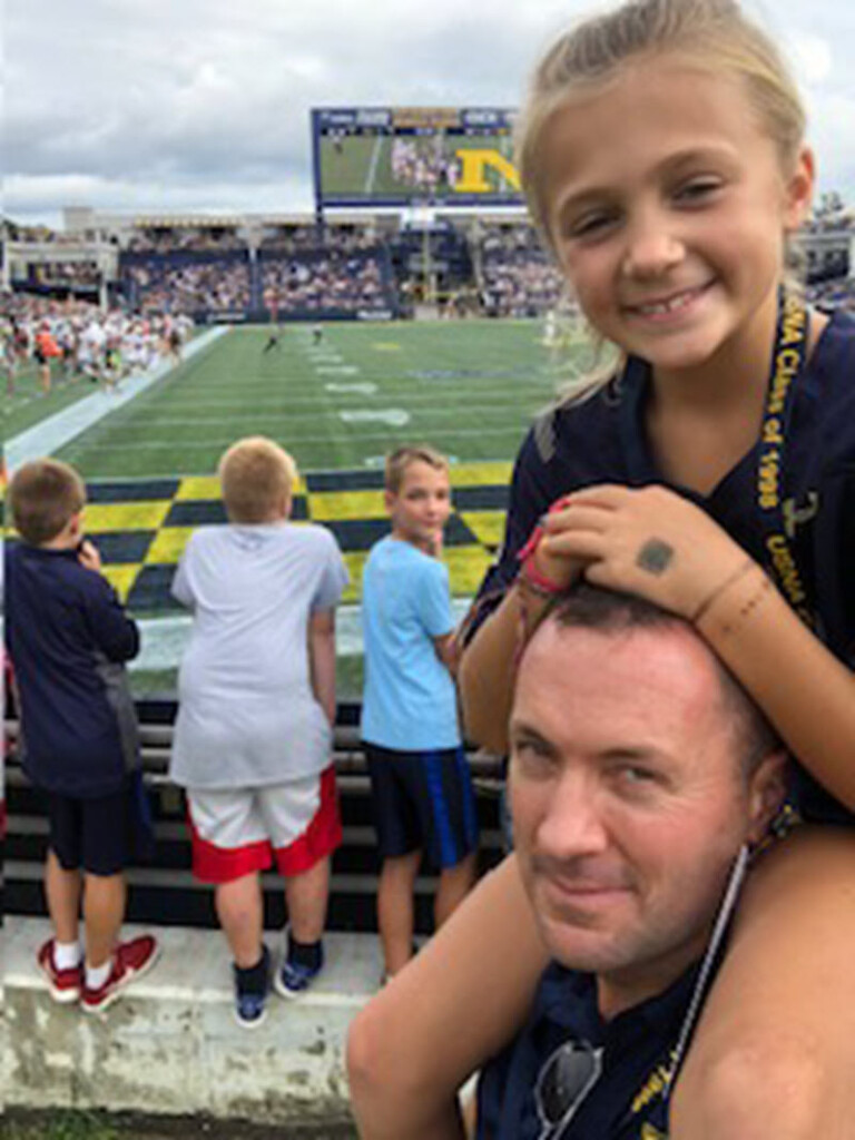 (PHOTO: US Marine Corps veteran and Bradford Avenue resident Tony Bancroft at the 2022 Navy Football Game in Annapolis, MD, with his daughter Anna.)