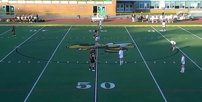 (PHOTO: Rye Varsity Field Hockey lines up across from rival Lakeland before their game on Tuesday evening.)