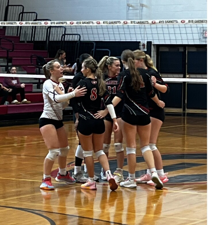 (PHOTO: The Rye Volleyball team huddles during the first set against Harrison on Thursday, October 24.)