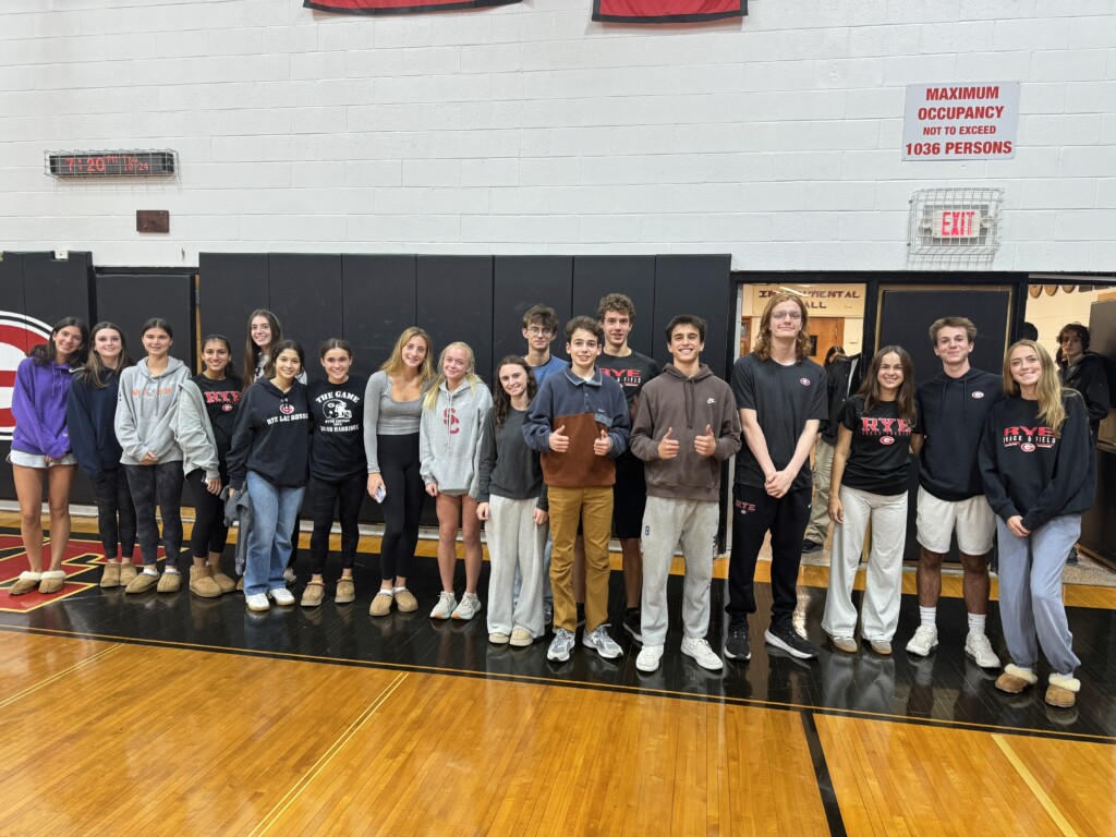 (PHOTO: The Girls and Boys Varsity Cross Country Team at the annual pre-Rye - Harrison Varsity football game pep rally and bonfire on Thursday, October 24, 2024.)