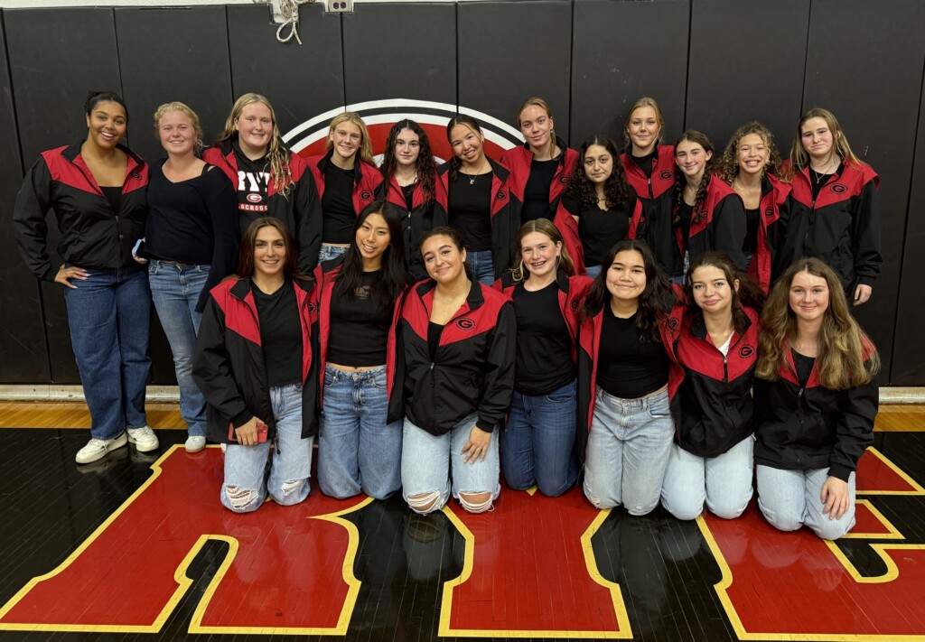 (PHOTO: The Girls Varsity Swimming & Diving Team at the annual pre-Rye - Harrison Varsity football game pep rally and bonfire on Thursday, October 24, 2024.)