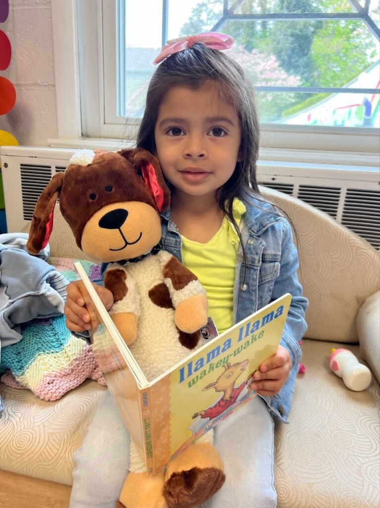 (PHOTO: 5 Steps to Five. Program participant reading to her “reading buddy” at All Souls Community Center in Port Chester, spring 2024. Contributed.)