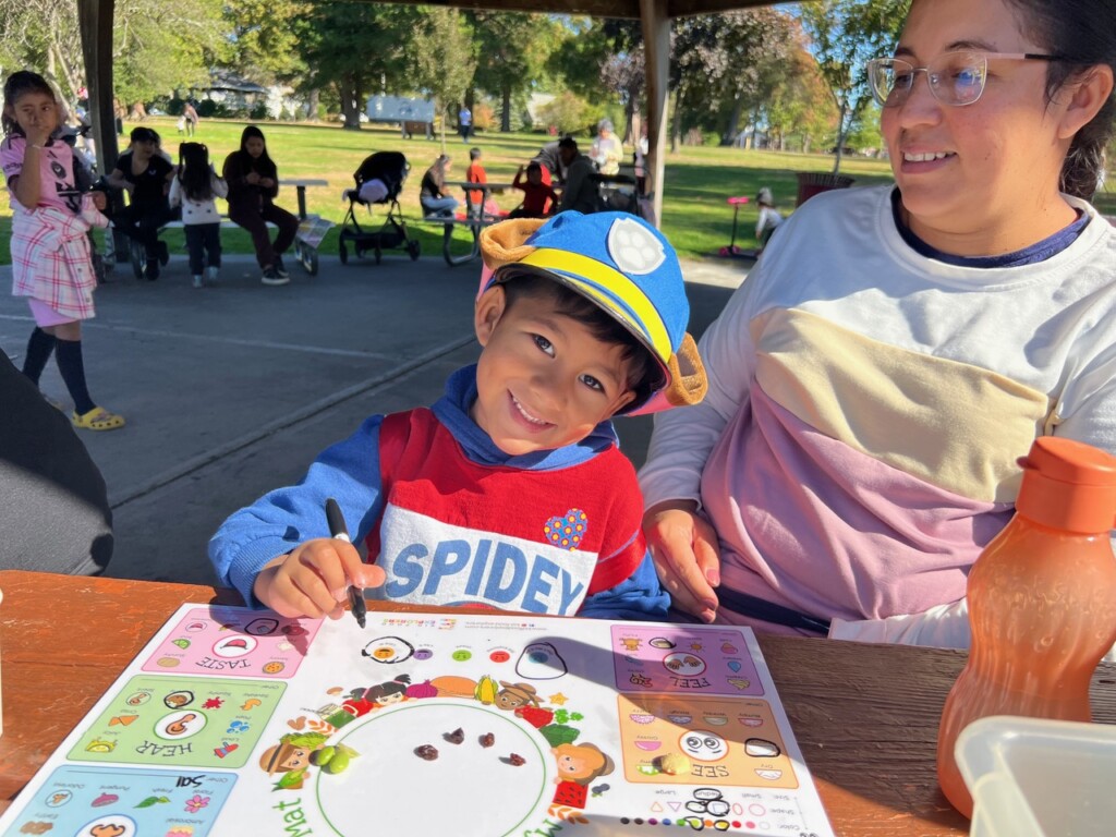 (PHOTO: 5 Steps to Five participants trying and rating new food as a part of nutrition programming at the pavilion at Lyon Park in Port Chester in the Fall of 2024. Contributed.)