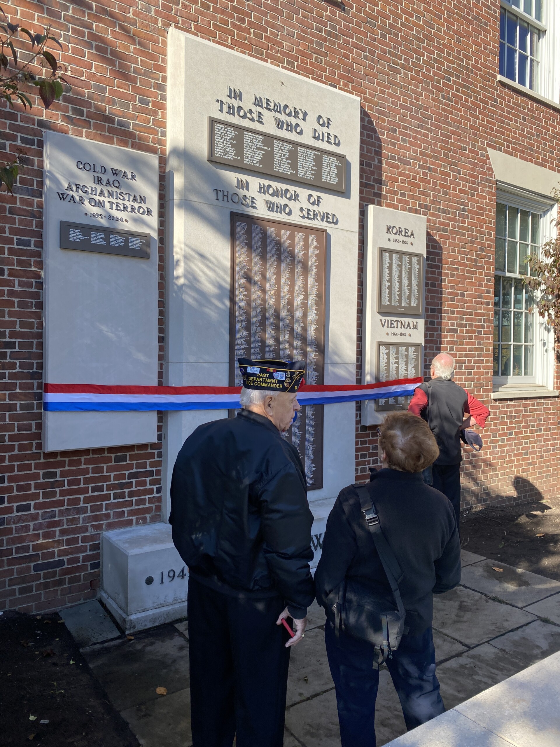 (PHOTO: Taking a moment at the new memorial plaques on Veterans Day November 11, 2024.)