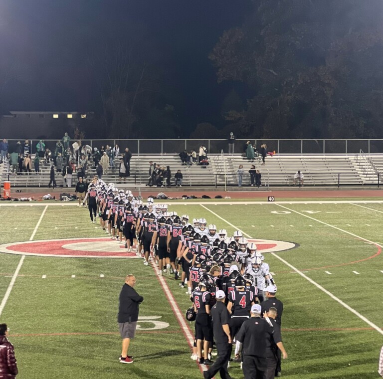 (PHOTO: Rye Football shakes hands with Brewster after defeating them 34-14 in their round one meeting. Credit: Rye Athletics)