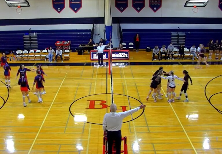 (PHOTO: Rye huddles after winning a point in set one against Byram Hills. the Garnets would go on to lsoe the match, eliminating them from the sectional tournament.)