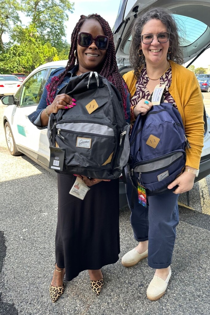 (PHOTO: Two caseworkers picking up backpacks from the The Sharing Shelf. Contributed.)