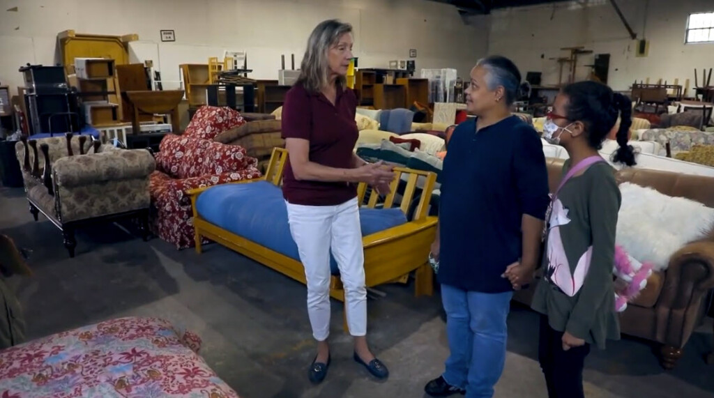 (PHOTO: Furniture Sharehouse Founder and Executive Director Kate Bialo in the organization's warehouse with a client. Contributed.)