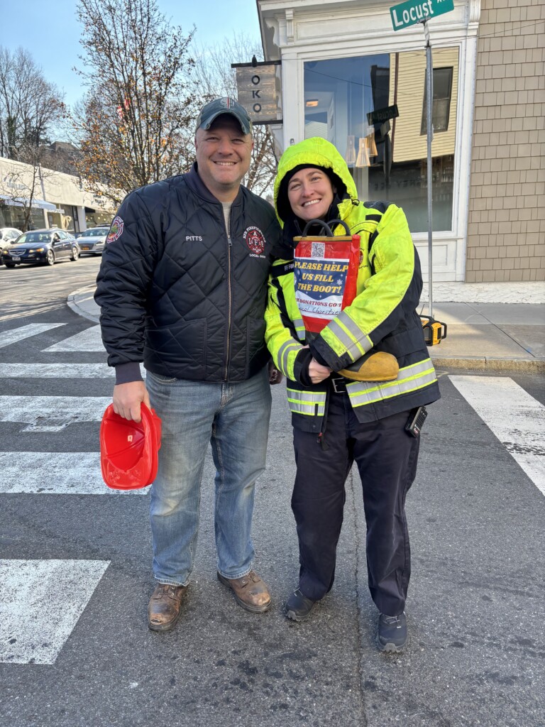 (PHOTO: Rye PD Local 2029 raised $8,472 during the union's annual boot drive on Saturday, December 7, 2024. Captain Clyde Pitts and Fire Fighter Cea Fong on Purchase Street. Contributed: Local 2029.)