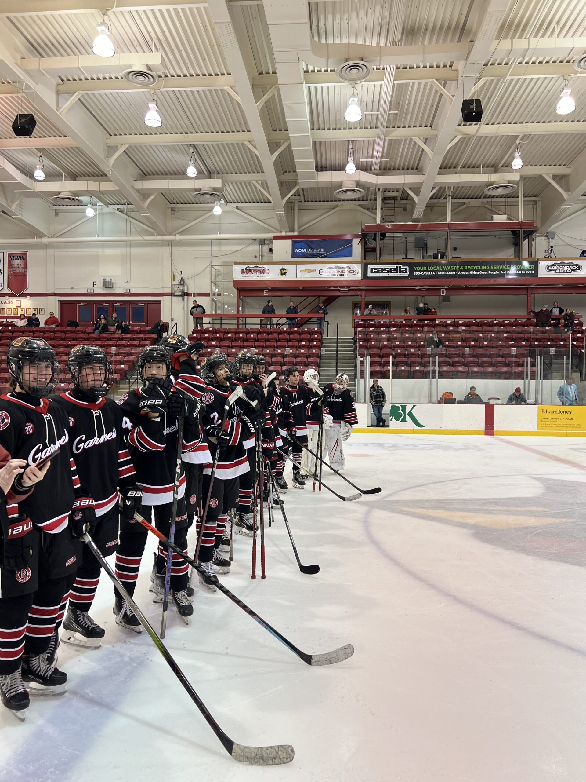 (PHOTO: Rye Varsity Hockey lining up on the blue line after winning the Applebee’s Winter Classic Tournament in 2024.)