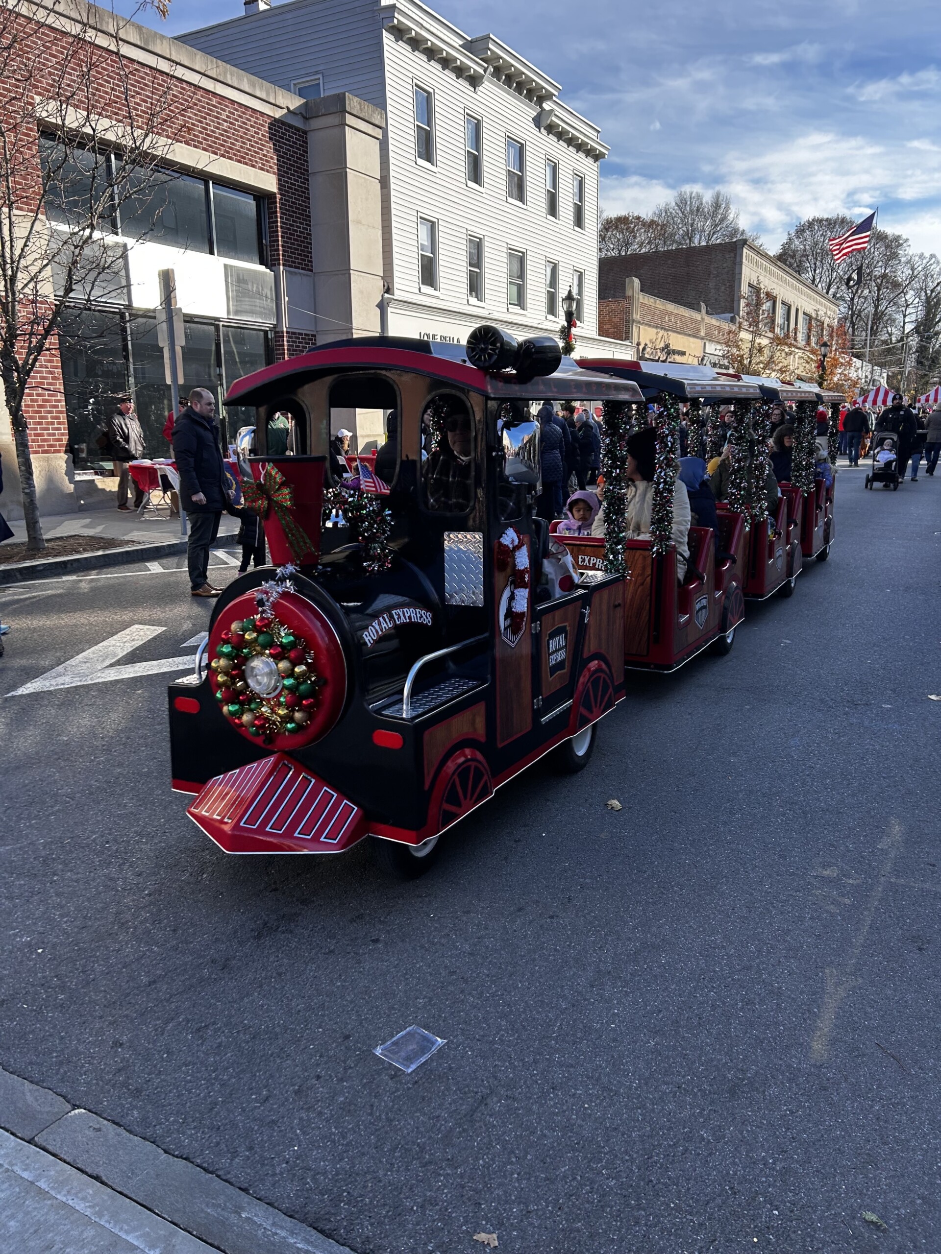 (PHOTO: To those who did not prefer the smell of the horses, a downsized, festive Metro North train offered rides up and down Purchase Street.)