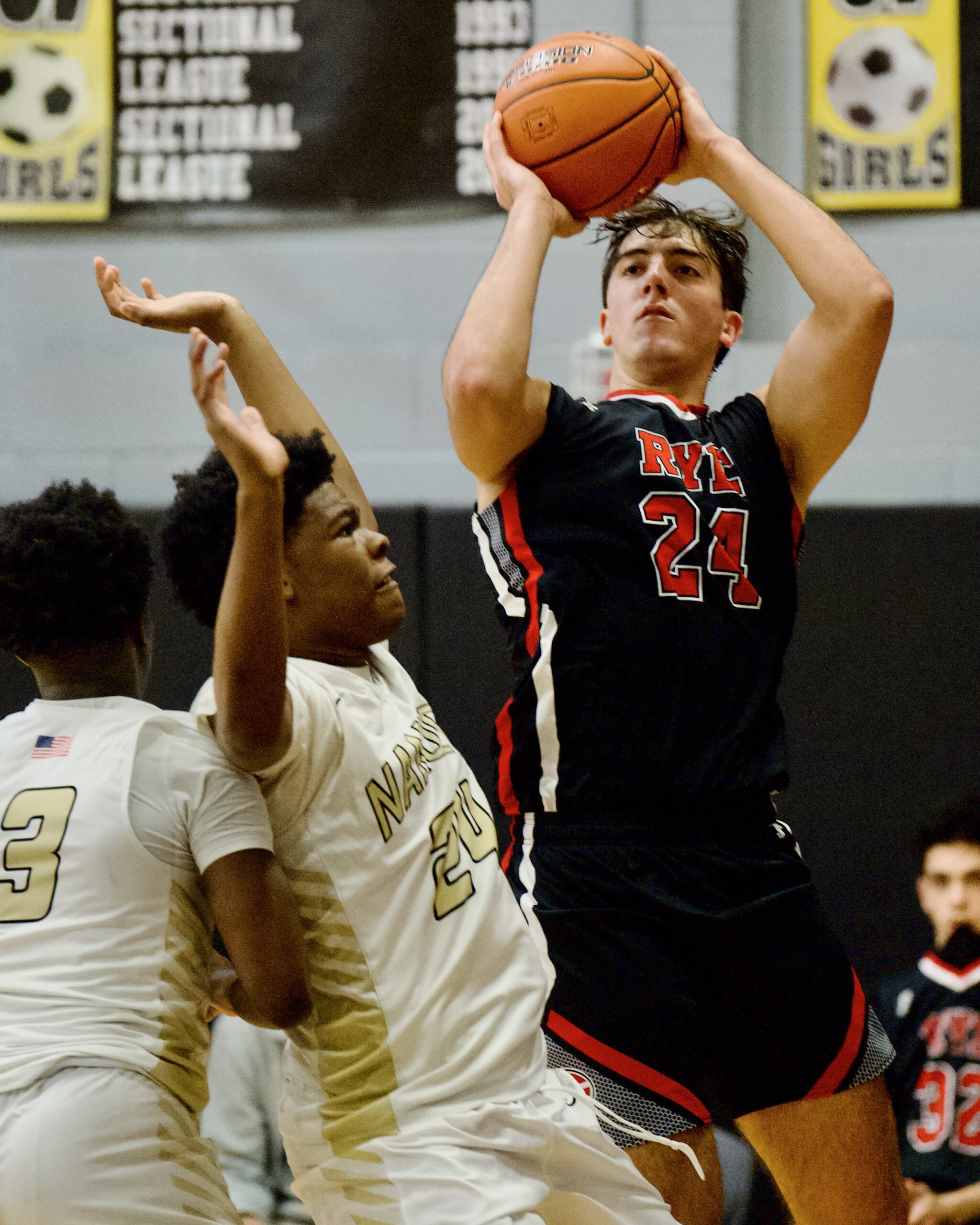 (PHOTO: Rye's Jake Kessner goes up for a shot in the loss to Nanuet.)